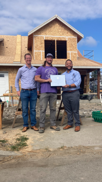 Rep Kilmer, Nick Jackson and Michael Smith pose on a Habitat build site