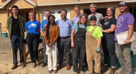 current and former AmeriCoprs members on Habitat build site