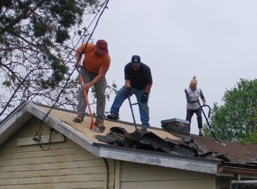 Volunteers replace a roof for a disabled veteran